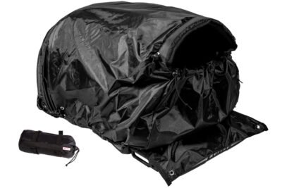 Black rainfly tarp over motorcycle dog carrier with stuff sack