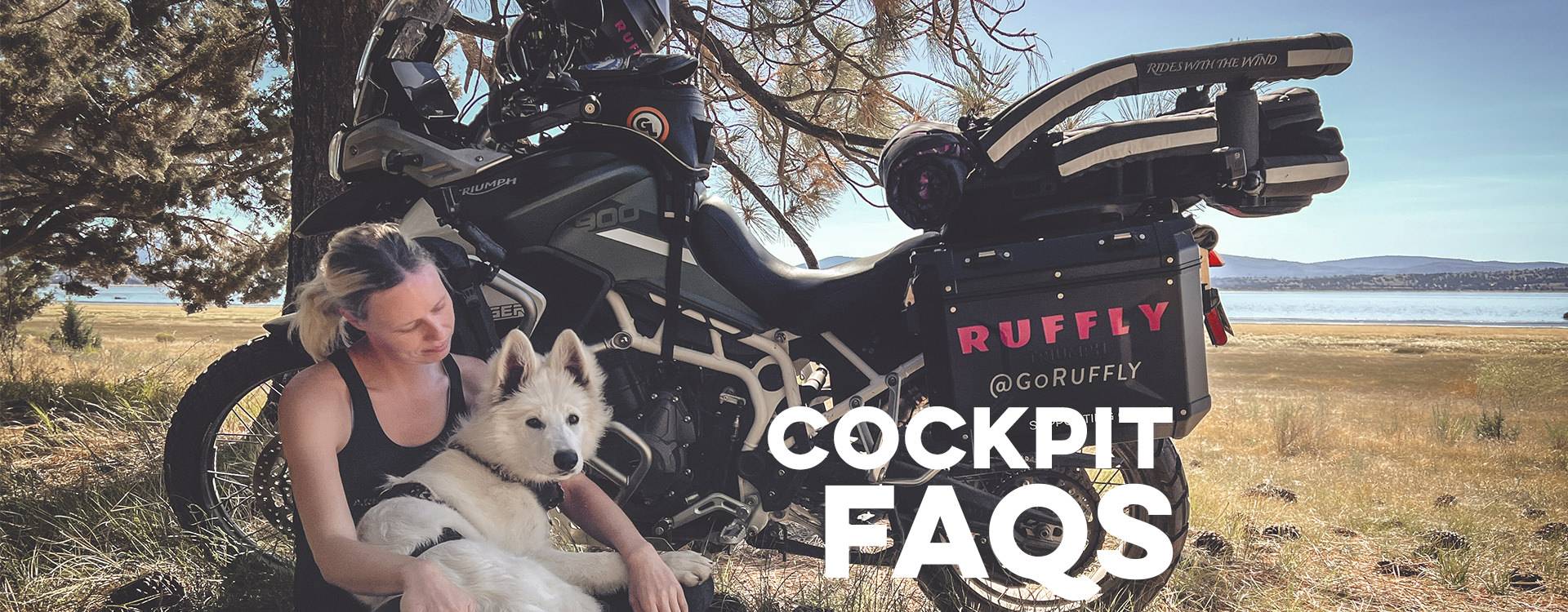 Woman reclines against an adventure motorcycle with her white Swiss shepherd in her lap with overlaid text: "Cockpit FAQs"