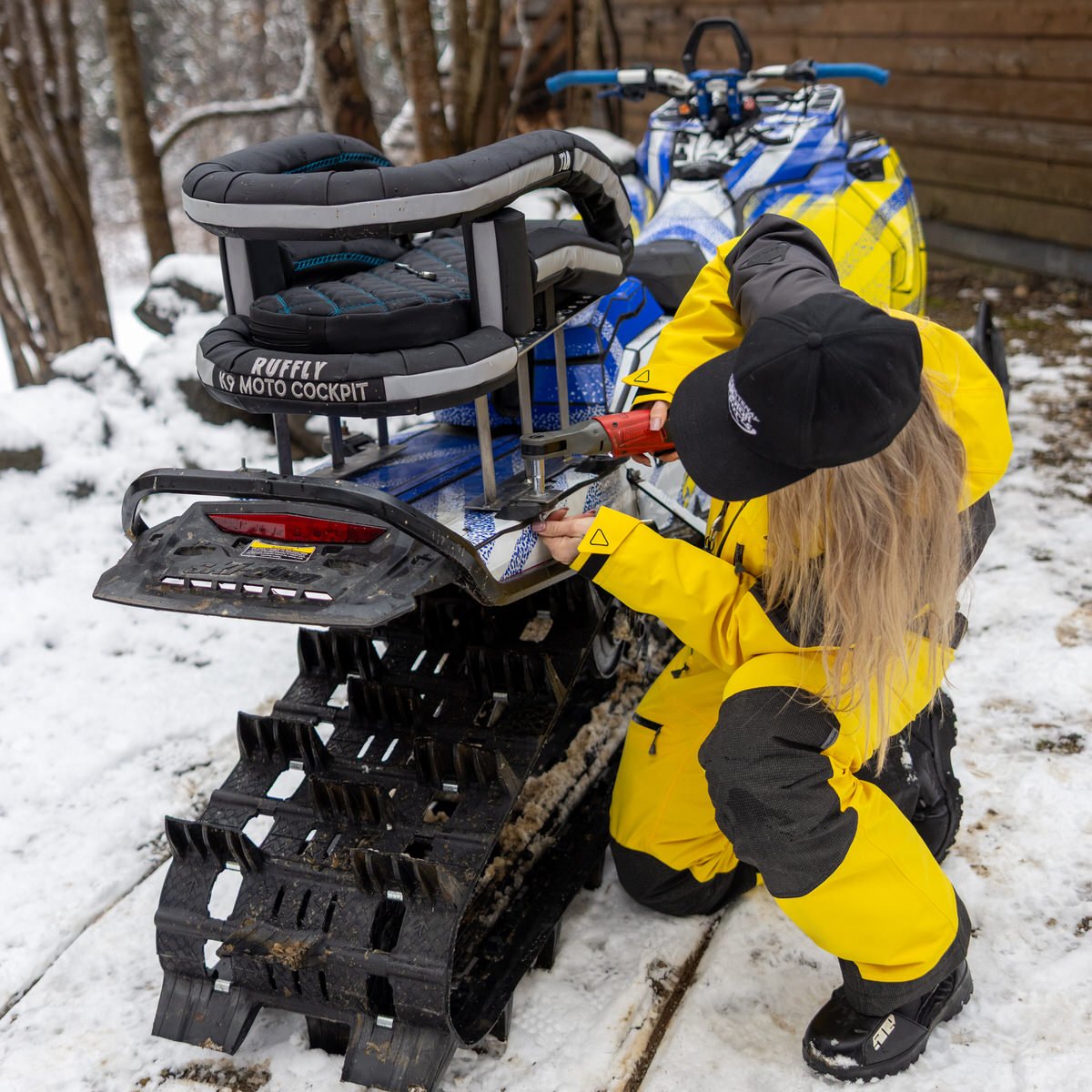 Shena installs Cockpit on Ski-Doo snowmobile Woman installs dog carrier on Ski-Doo snowmobile